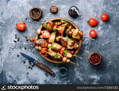 Chicken kebab on skewers with mushrooms and tomato. Grilled shish kebab on skewers