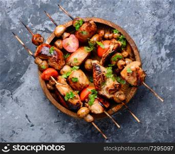 Chicken kebab on skewers with mushrooms.Barbeque meat dish. Grilled shish kebab on skewers