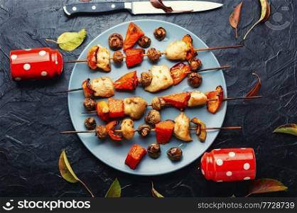 Chicken kebab with pumpkin and mushrooms on skewers. Skewer with chicken and pumpkin