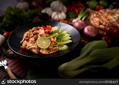 Chicken Larb on the plate With dried chilies, tomatoes, spring onions and lettuce.