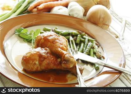 Chicken legs baked in tomato sauce with green beans on the side