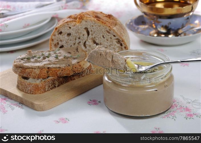 Chicken liver pate on bread and in jar