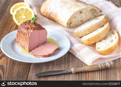 Chicken liver pate with ciabatta on the white plate