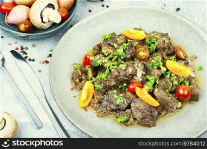Chicken liver roasted with mushrooms and tomatoes. Liver in Georgian. Delicious Georgian chicken liver.