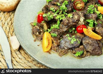 Chicken liver roasted with mushrooms and tomatoes. Liver in Georgian. Delicious Georgian chicken liver.