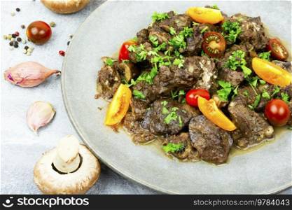 Chicken liver stewed with mushrooms and tomatoes. Georgian recipe. Fried chicken liver
