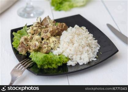 chicken liver with rice garnish and herbs