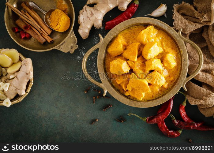 Chicken masala curry, spicy meat. Yellow chicken curry sauce. Spicy chicken curry dish. Traditional indian food, asian cuisine. Top view