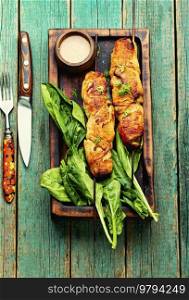 Chicken meat, chicken breast fried on skewers with peanut butter sauce, wooden background. Chicken breast fried on skewers, souvlaki