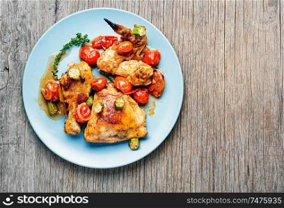 Chicken meat stewed in tomatoes, okra and spices.Space for text. Baked chicken with vegetables