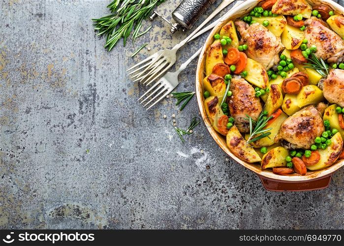 Chicken meat, thighs baked with potato, carrot and green peas