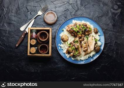Chicken meat with mushroom sauce on a rice pad. Meat with Sicilian marsala sauce.. Chicken breast with marsala sauce and rice