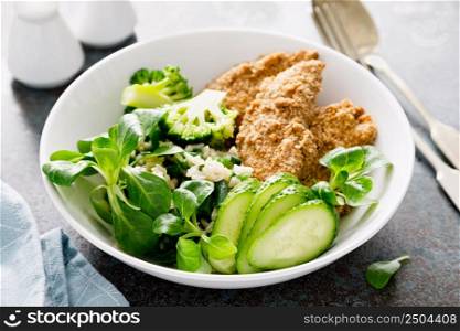 Chicken nuggets with fresh corn salad, broccoli, cucumber and rice