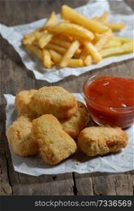 Chicken nuggets with ketchup and french fries
