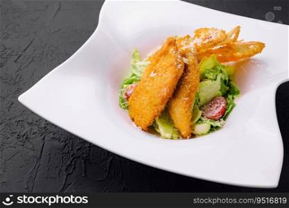 Chicken nuggets with vegetables salad on plate