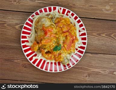 Chicken paprikash - Traditional hungarian chicken cooked in paprika and cream sauce. Served noodles.