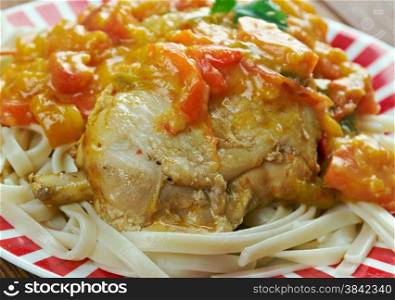 Chicken paprikash - Traditional hungarian chicken cooked in paprika and cream sauce. Served noodles.