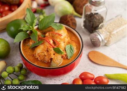 Chicken red curry in a black bowl, chilli, tomato, galangal, shiitake mushroom and eggplant