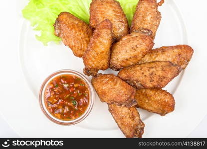 chicken roasted wing dish with sauce on a white background