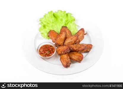 chicken roasted wing dish with sauce on a white background