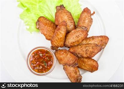 chicken roasted wing dish with sauce on a white background