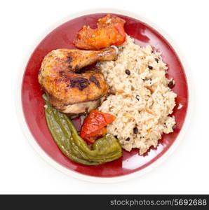 Chicken roasted with tomatoes and long sweet peppers and served with a pilaf
