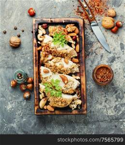 Chicken roll baked in breadcrumbs from nuts. Stuffed chicken breast with nuts.