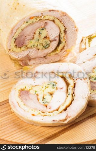 chicken roll with omelette on the wooden board