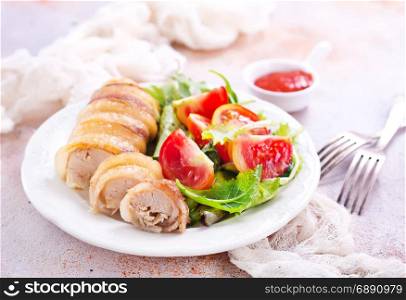 chicken roll with salad on the white plate