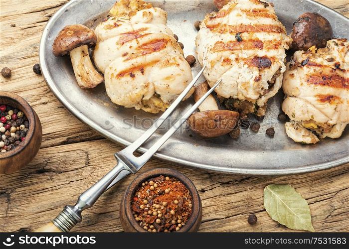 Chicken rolls stuffed with wild mushrooms on metal stylish dish. Chicken roll with mushrooms