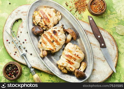 Chicken rolls stuffed with wild mushrooms on metal stylish dish. Chicken roll with mushrooms