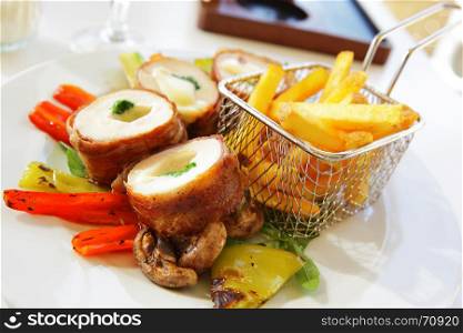 Chicken rolls with cheese, vegetables and fried potatoes