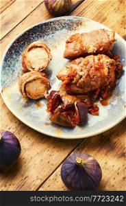Chicken rolls with figs in wine sauce.Baked chicken with figs. Chicken breast roll roast with figs