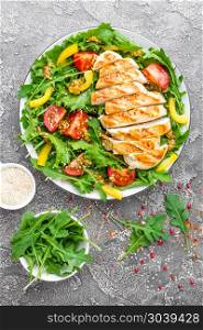 Chicken salad. Meat salad with fresh tomato, sweet pepper, arugula and grilled chicken breast. Chicken fillet with fresh vegetable salad