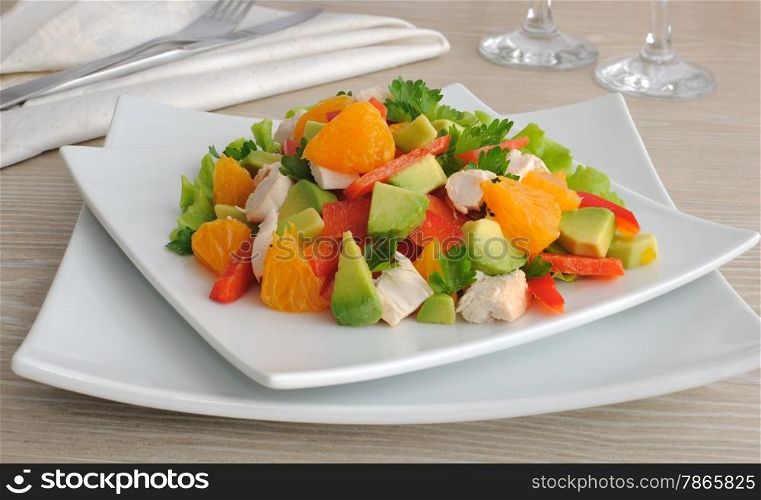 Chicken salad with avocado, sweet pepper and orange