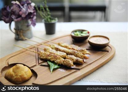 Chicken Satay on wood