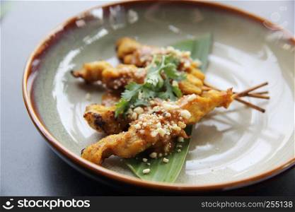 chicken satay, sate ayam and lontong with peanut sauce
