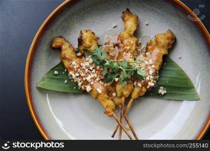 chicken satay, sate ayam and lontong with peanut sauce