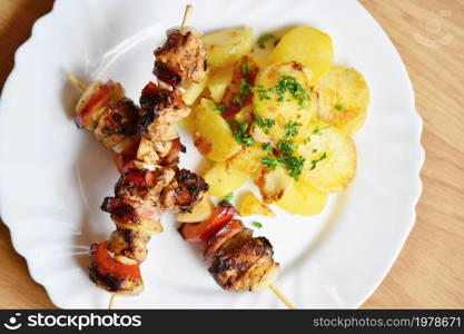 Chicken skewer with potatoes and parsley. Excellent meat with vegetables.