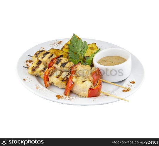 Chicken skewers with potatoes and sauce on isolated background. Chicken skewers with potatoes and sauce