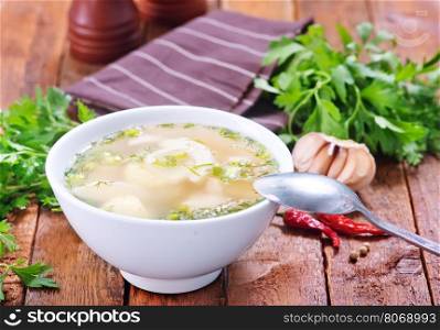 chicken soup in bowl and on a table