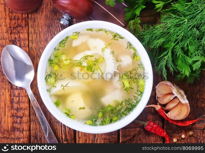 chicken soup in bowl and on a table