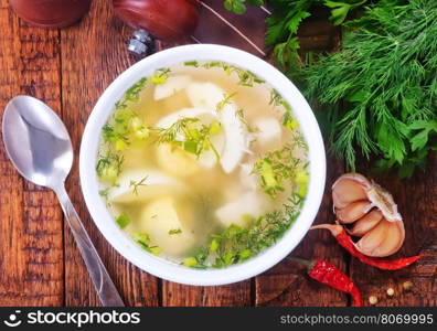 chicken soup in bowl and on a table