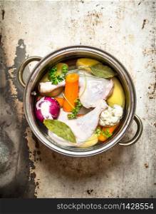 Chicken soup with vegetables. On rustic background .. Chicken soup with vegetables.