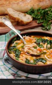 Chicken soup with white beans, spinach and tomato