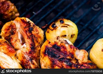 Chicken steak grilled and meat rolls on a charcoal barbeque. Top view of camping tasty barbecue, food concept, food on grill and detail of food on the grill