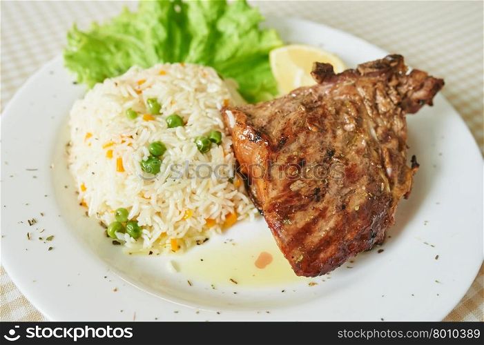 Chicken Steak with rice And Lettuce on white plate