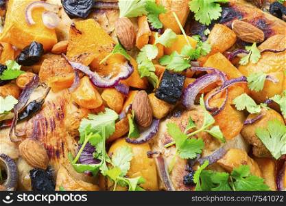 Chicken stew with pumpkin and quince.Food background, close-up.. Baked chicken with pumpkin.