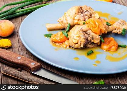 Chicken stewed in apricot sauce. Summer meat dish. Chicken stewed in apricots