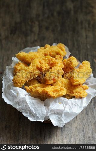 Chicken strips on rustic wooden table